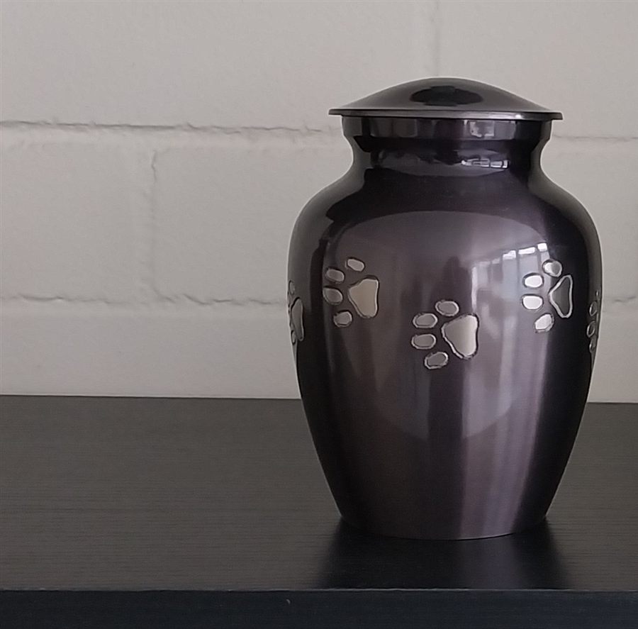 Plum-toned pet urn with silver paw print detail